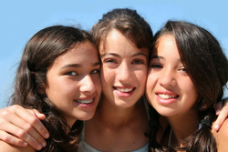 photo of three young girls embracing